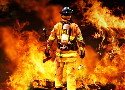 firefighter battling blazing fire