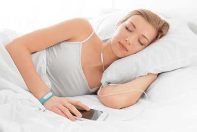 Woman sleeping with fitness tracker