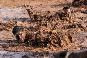 two competitor deep in mud during ocr race