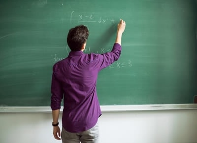 male teacher at blackboard