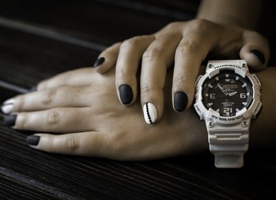 women's watch and hands with painted nails