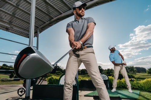 golfer at driving range with clubs