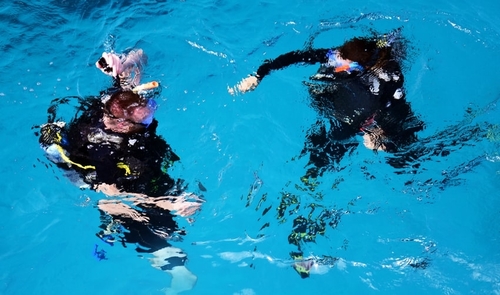 Pair of divers preparing for a dive