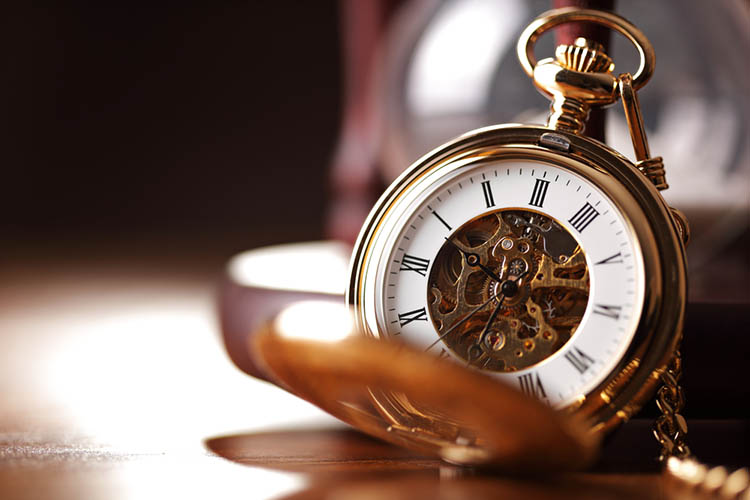 Gold pocket watch and hourglass