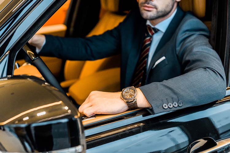 businessman with luxury watch in vehicle