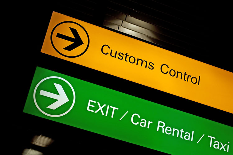 Airport customs, exit, car rental and taxi sign.