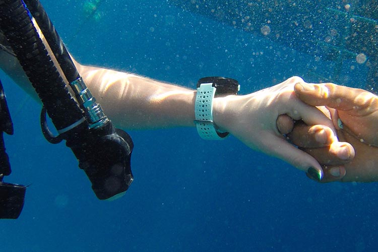 girl wearing watch in underwater diving