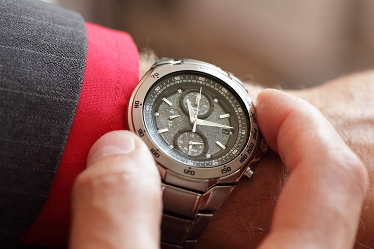 Businessman checking the time on his wrist watch