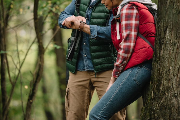 couple outdoors checking watch