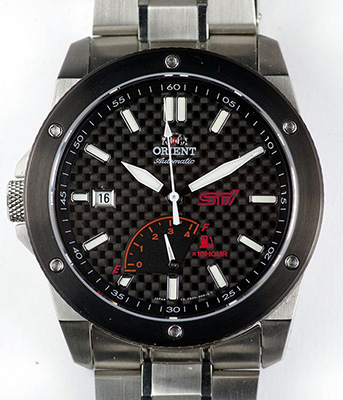 An Orient SFD0H001B watch. Stainless steel case, carbon fiber dial, power reserve indicator.