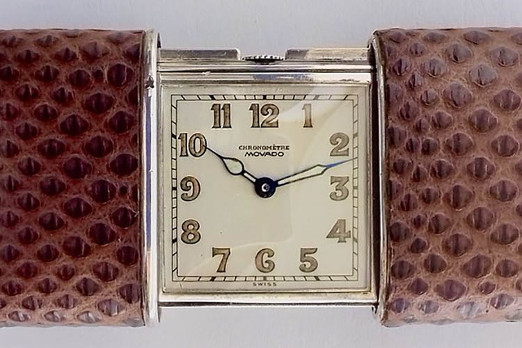 1928 Movado chronometer, silver case covered in lizard skin.