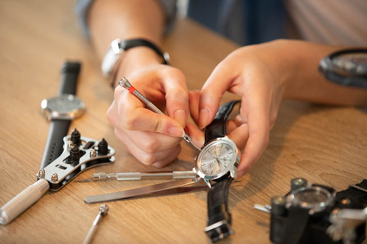 cropped image of a watch being repaired