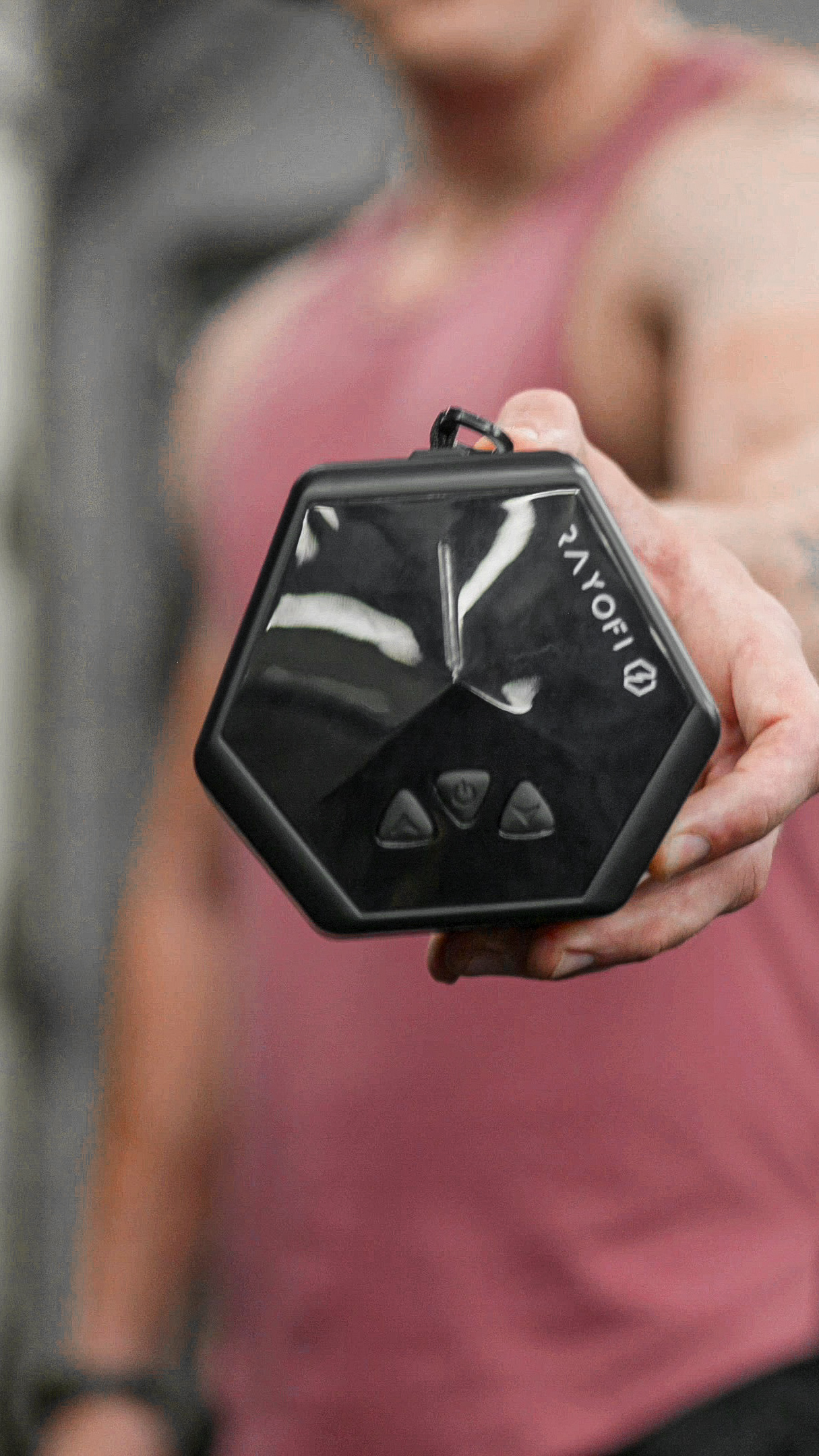 Rayofi GoTone Pro held in one hand, showing how compact the digital resistance device is